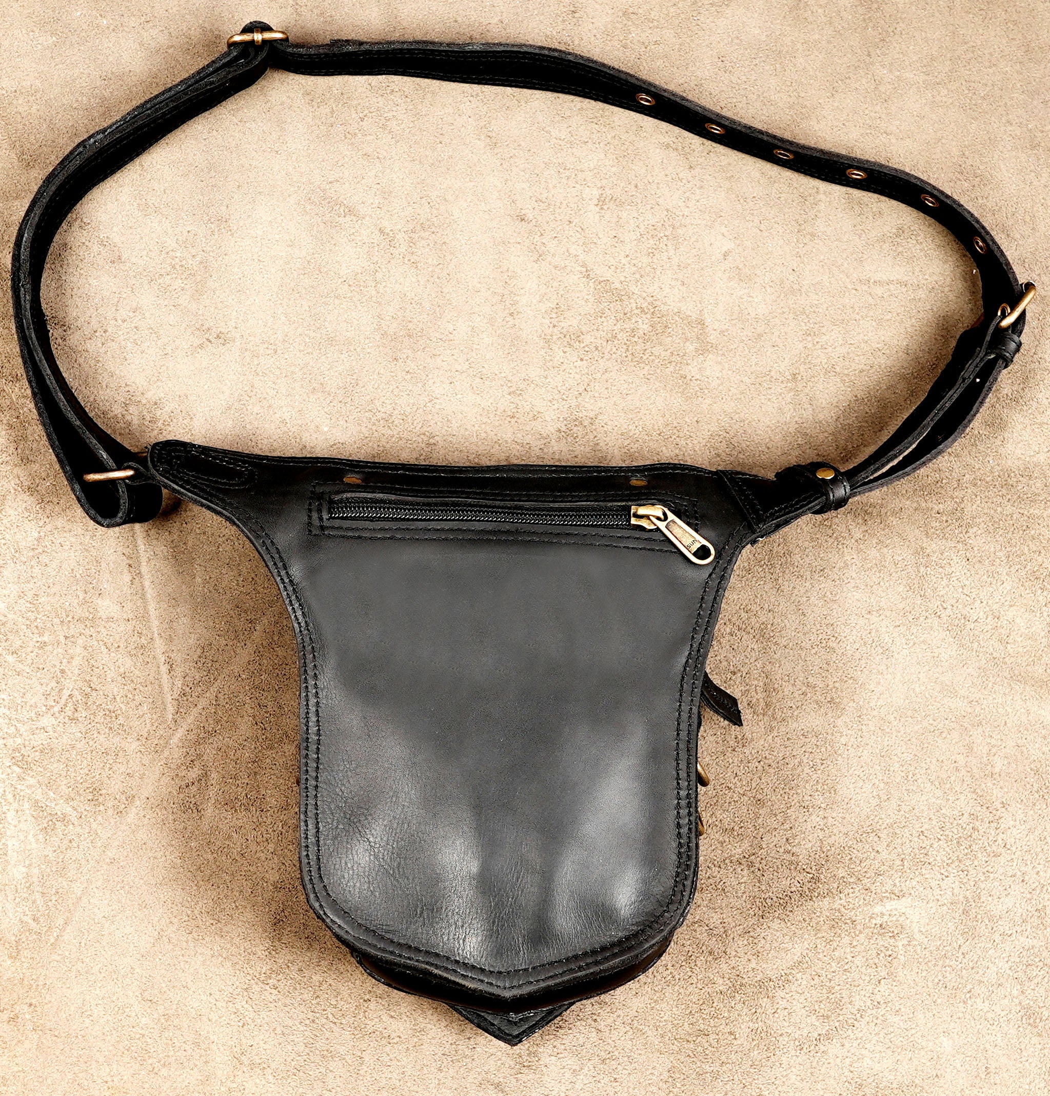 Black leather travel waist bag with decorative gemstone detail