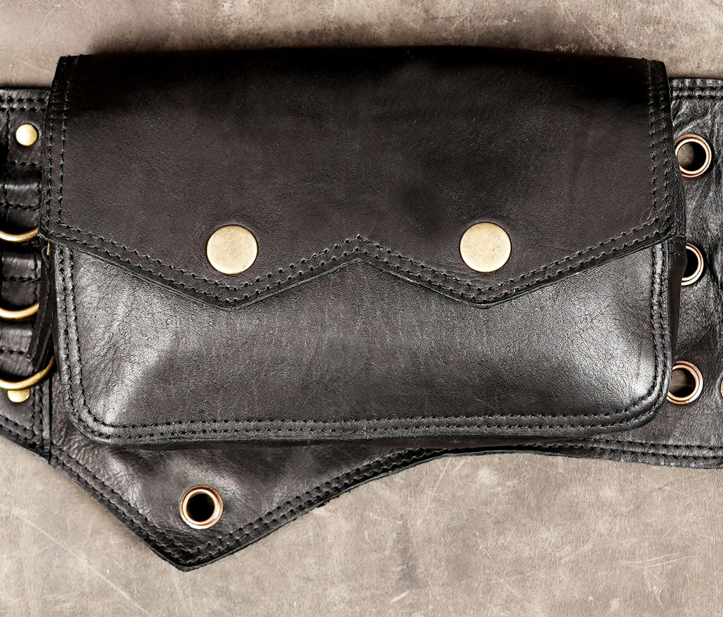 Black leather waist bag with antique brass hardware