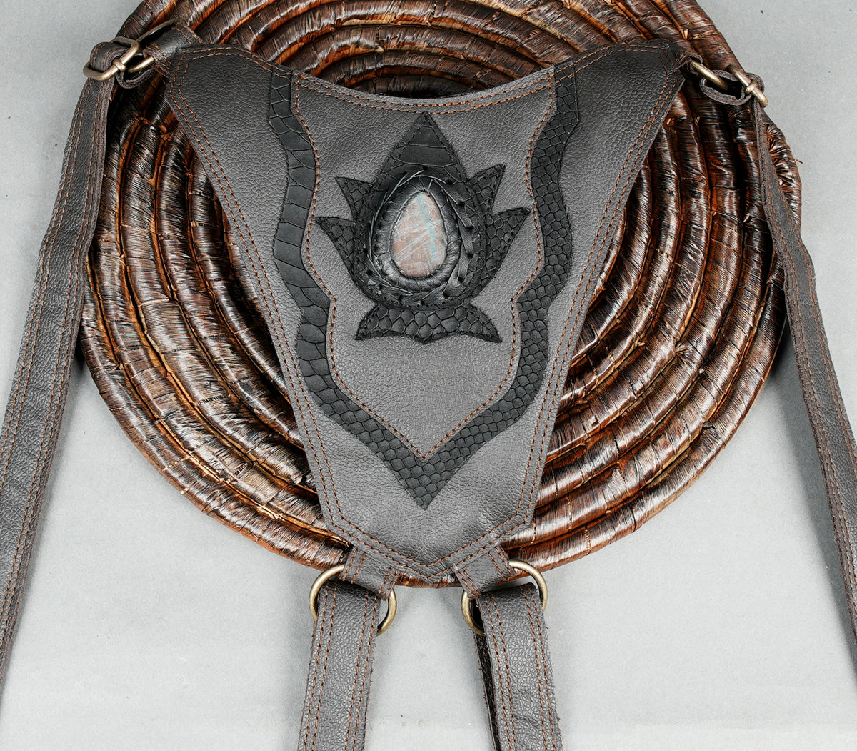 Grey leather double pouch harness with decorative lotus-inspired patterns and gemstone accents.