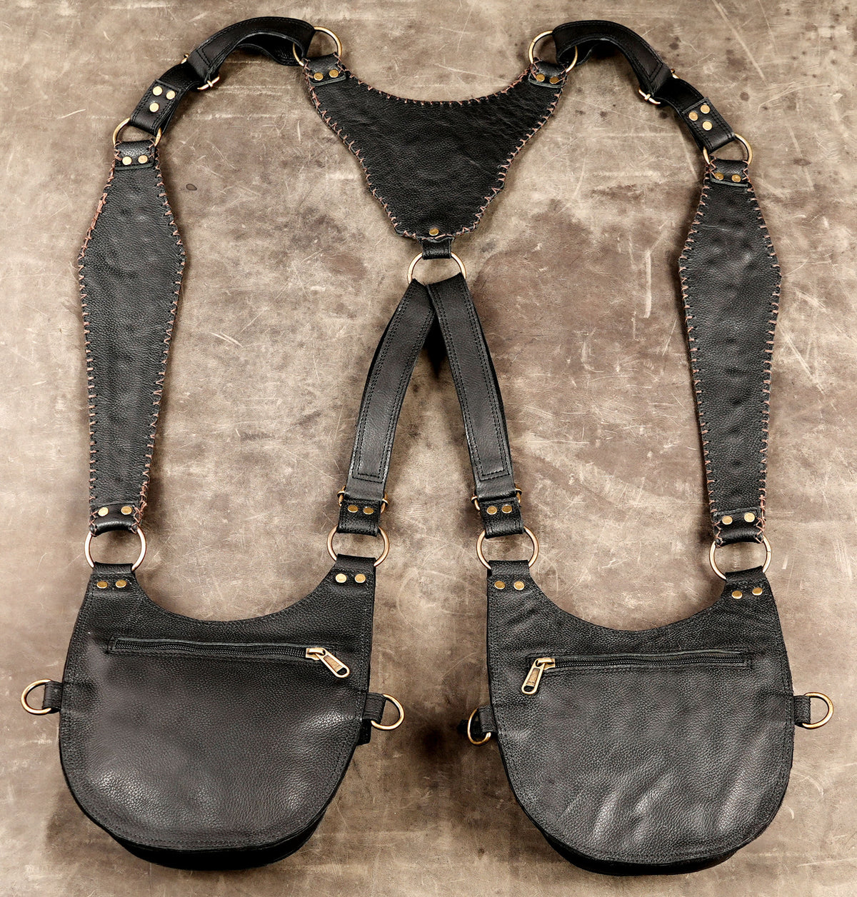 Decorative black leather utility bags with studded flaps and adjustable buckles