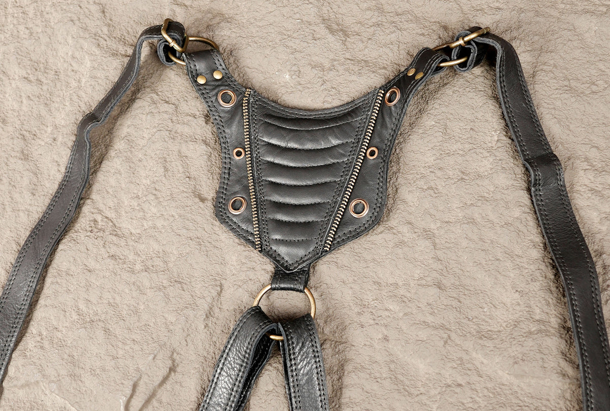 Gothic black waist harness bag with quilted panels brass-tone rivets and zipper details