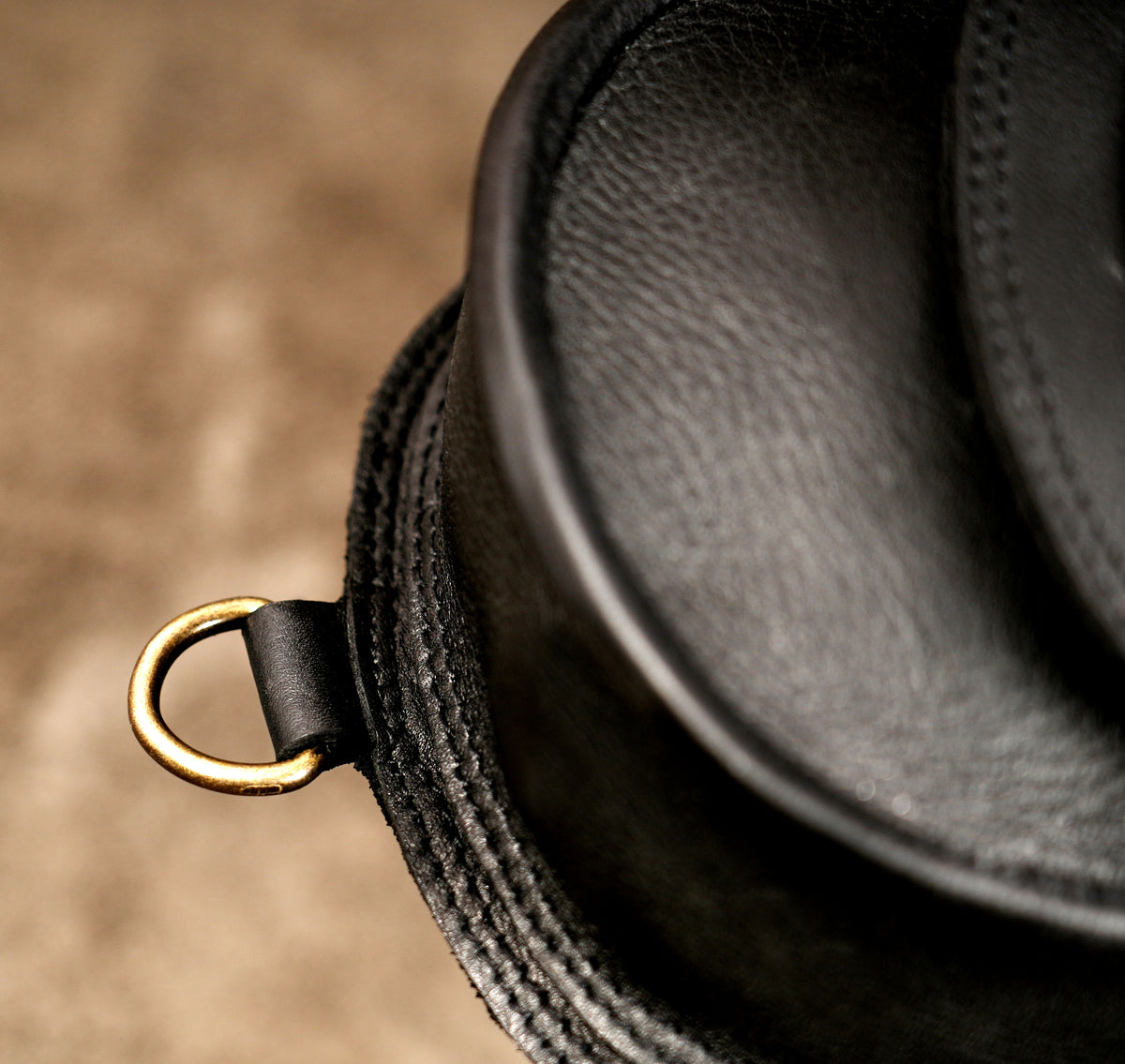 Black leather utility harness with adjustable shoulder straps and antique brass metal details.
