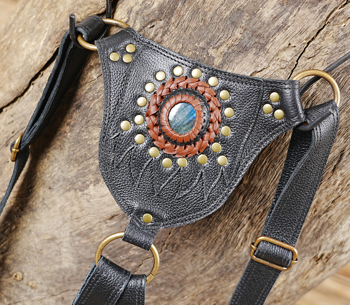 Unisex black leather chest bag with gemstone detailing and multiple adjustable straps
