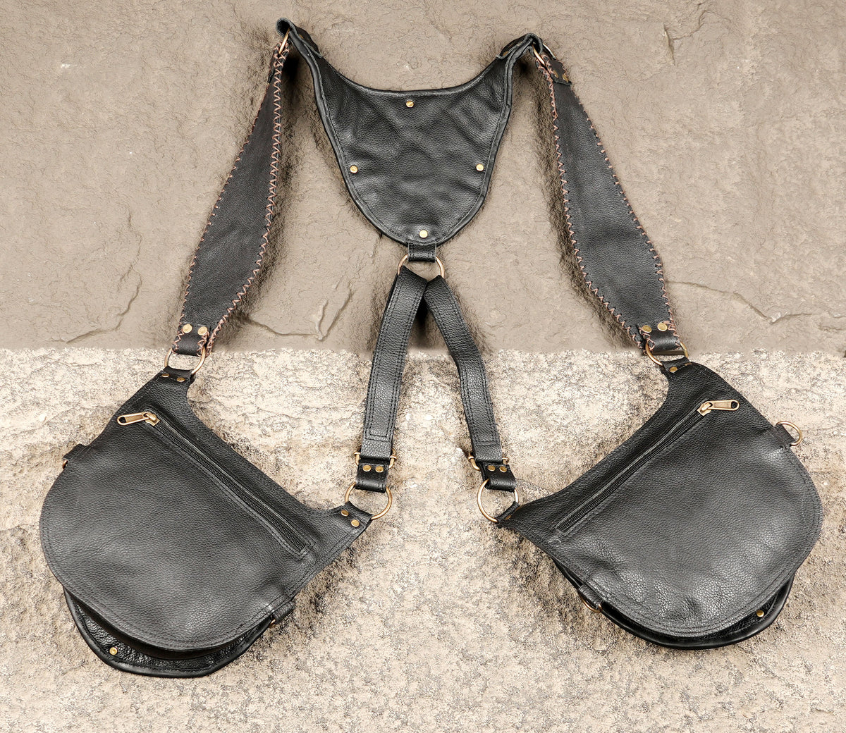 Black leather shoulder holster accessory with matching pouches and metal fasteners