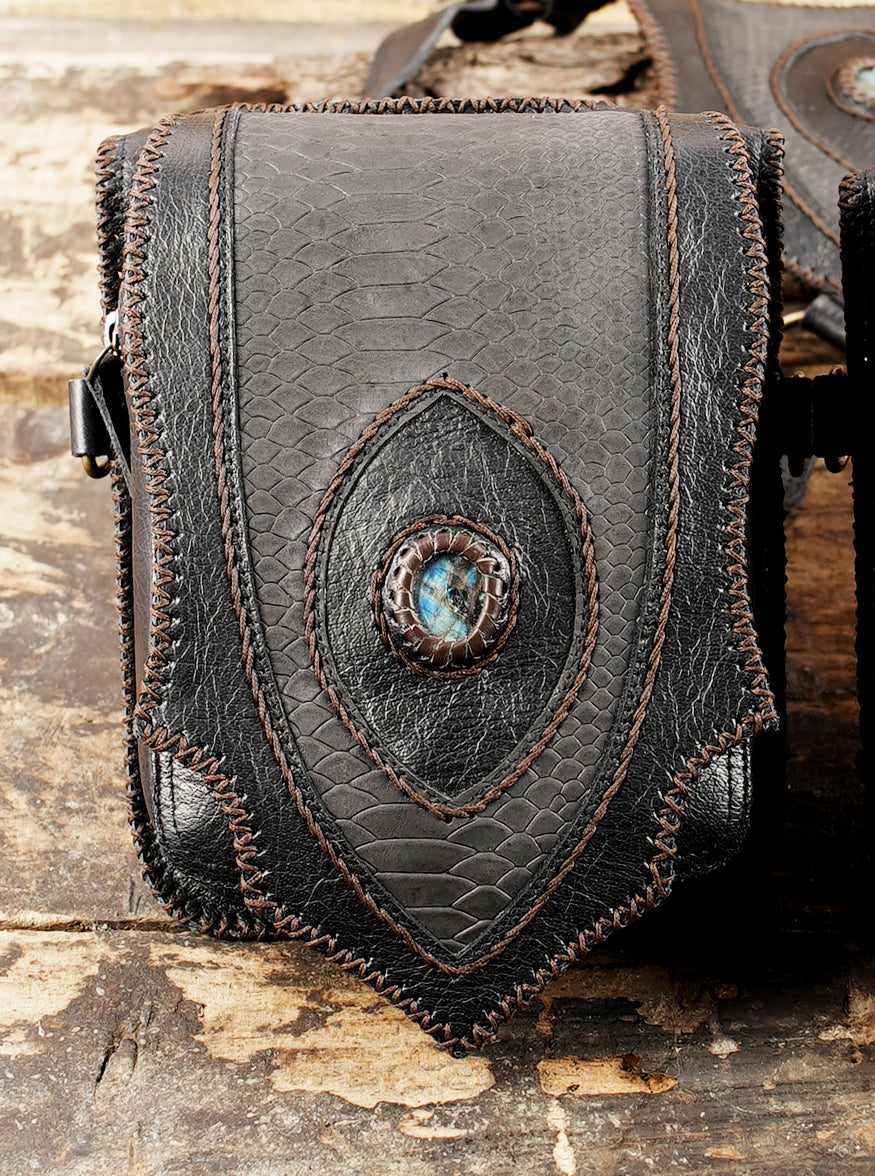 Black buffalo leather shoulder harness bag featuring antique brass hardware   