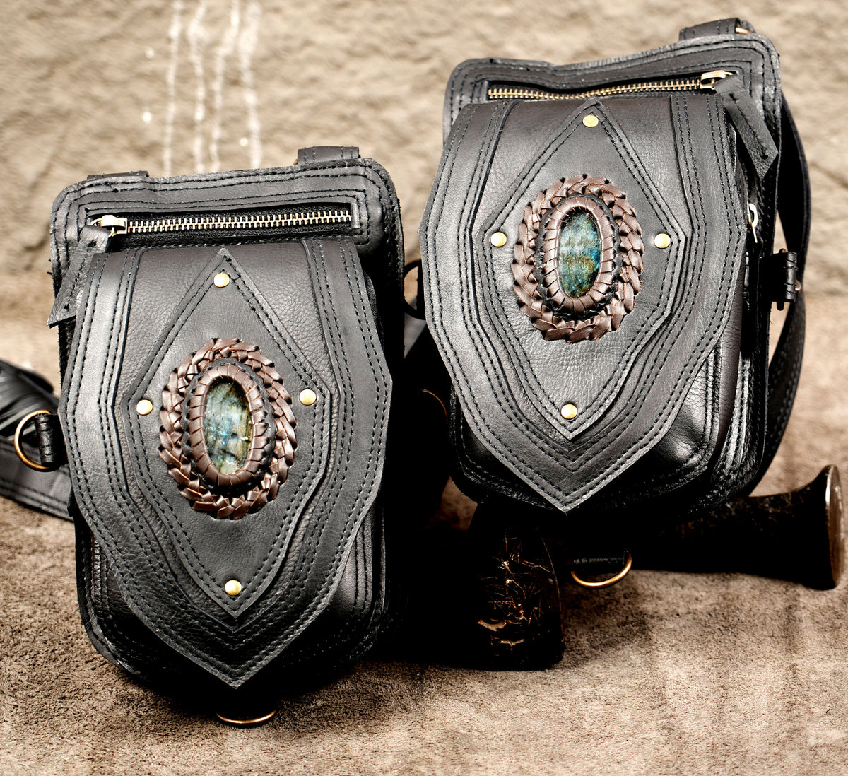 Adjustable unisex black leather utility harness with double zippered side pockets and quick-release clasps.