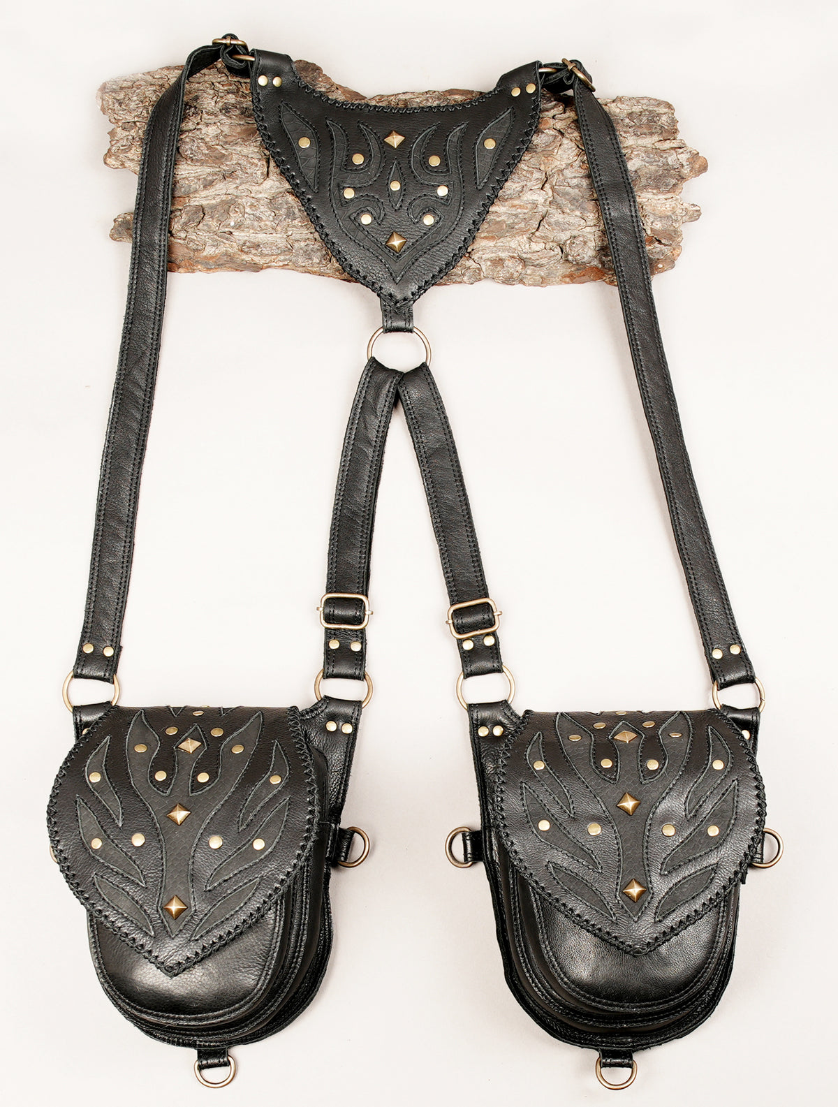Gothic black leather double holster bag with decorative metal studs for steampunk outfits and music festivals.