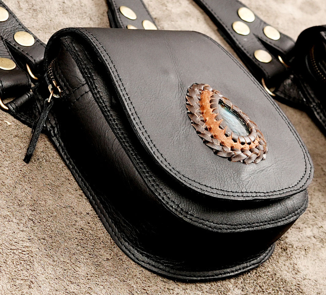 Unisex festival shoulder bag with black leather straps and metal studs