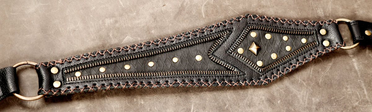 Black leather festival bag set with decorative stitching and metal accents