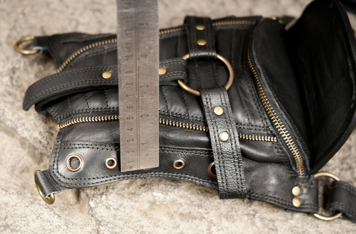 Black double pocket utility harness bag with quilted detailing and brass-tone hardware