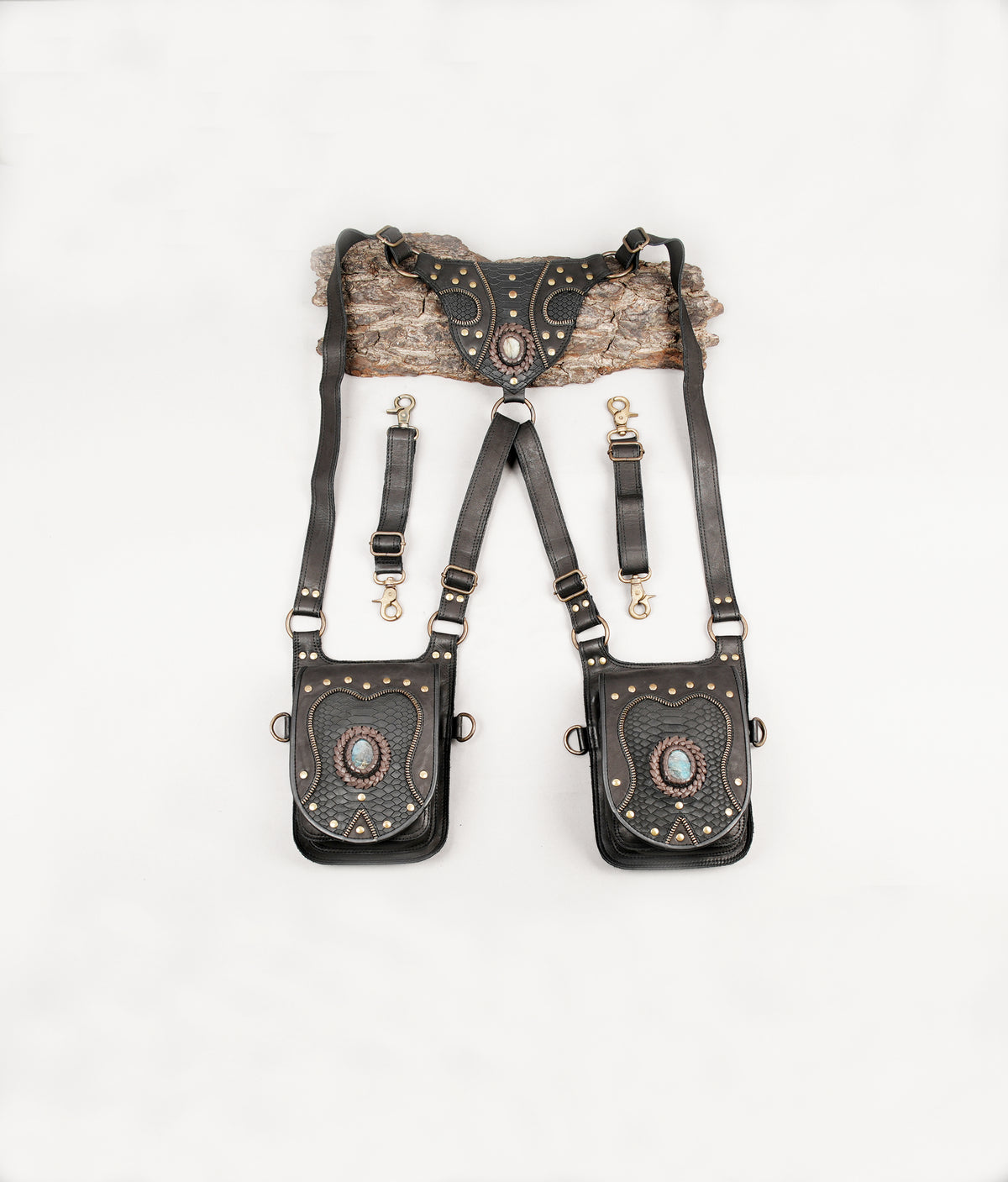 Unisex black leather harness bag with two decorative pouches and gemstone accents
