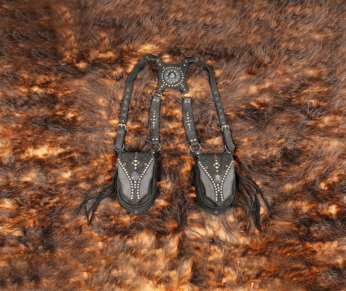 Black leather festival holster harness with two front pouches and dangling leather fringe.