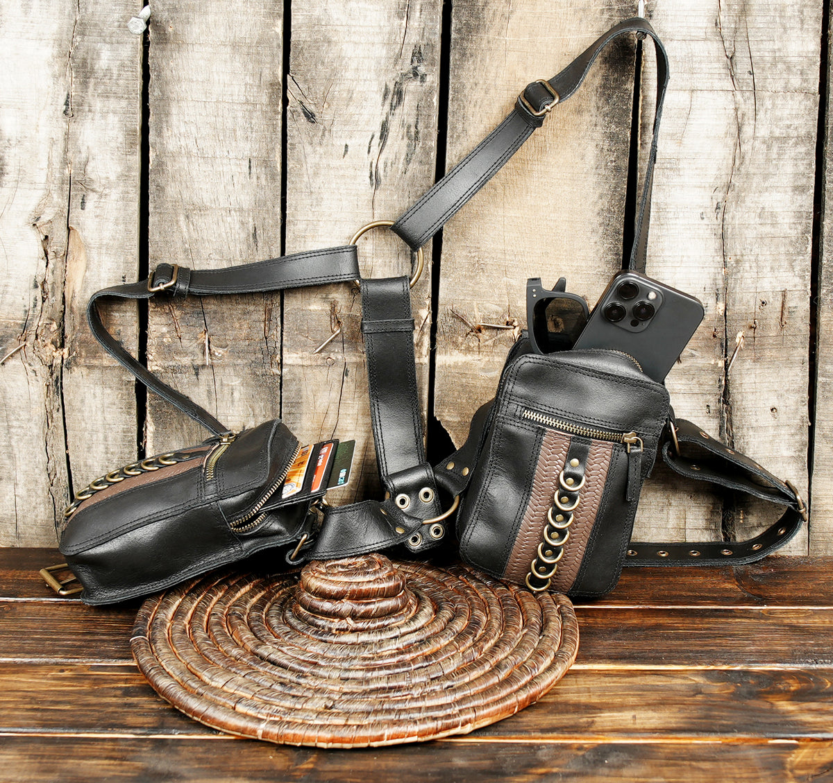 Unisex black leather tactical harness with storage pouches on wooden background   