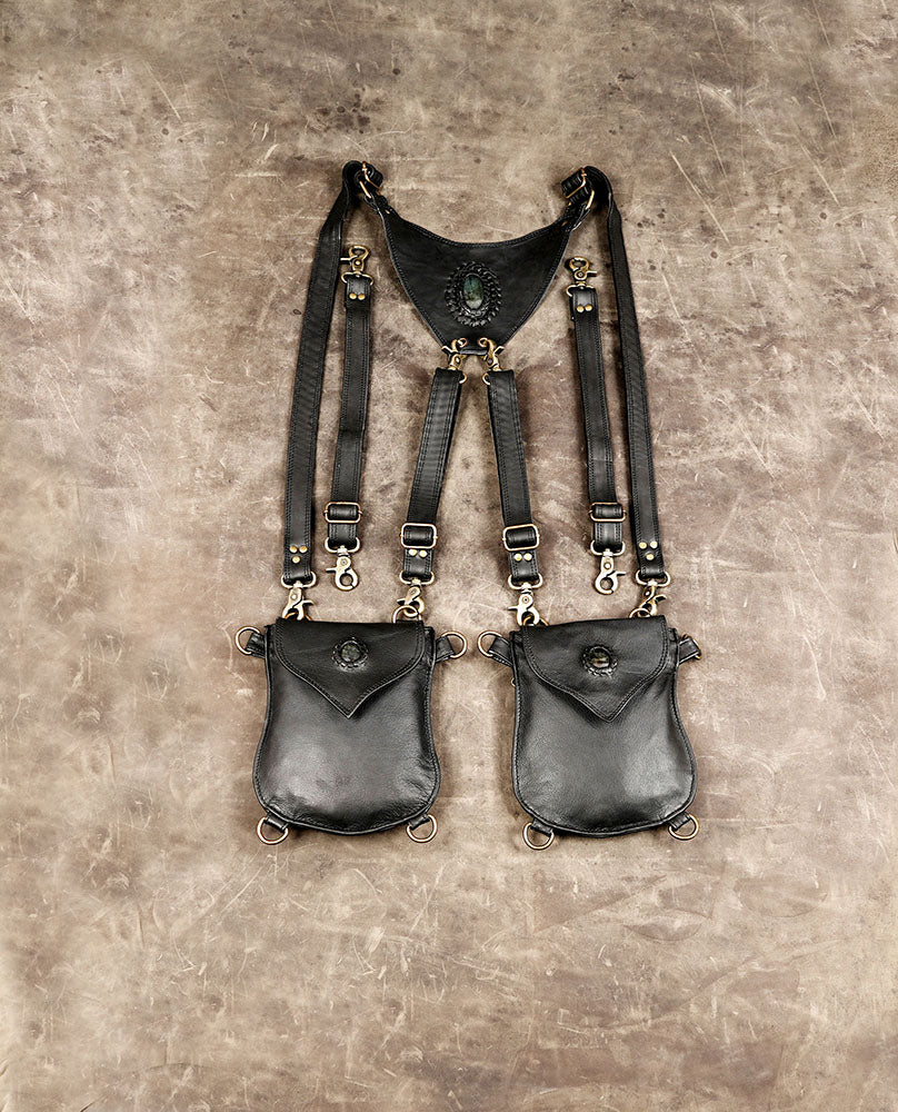 Black leather utility chest bag with double shoulder straps and pouches