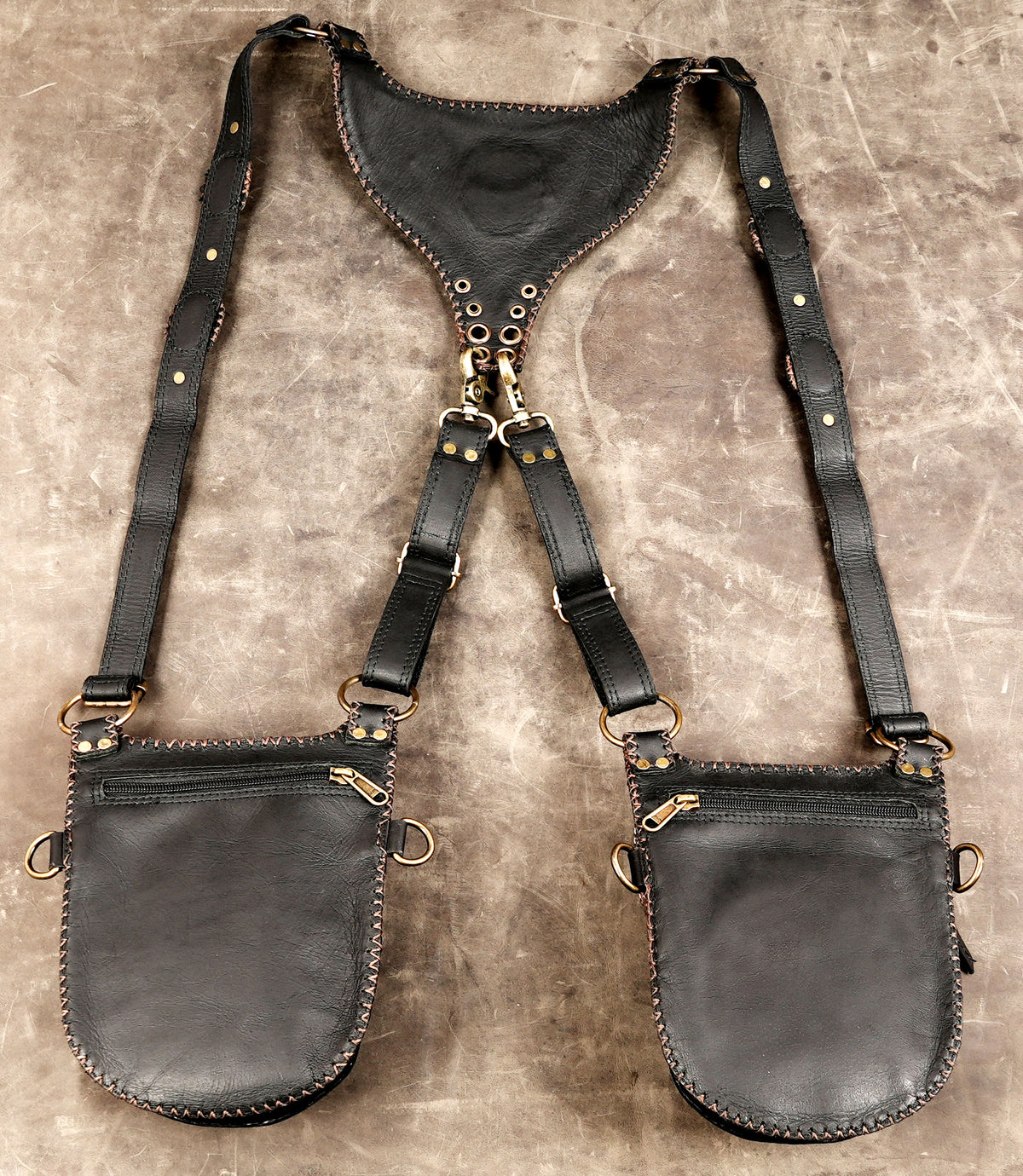 Statement fashion body harness featuring dual holster bags and metal clips
