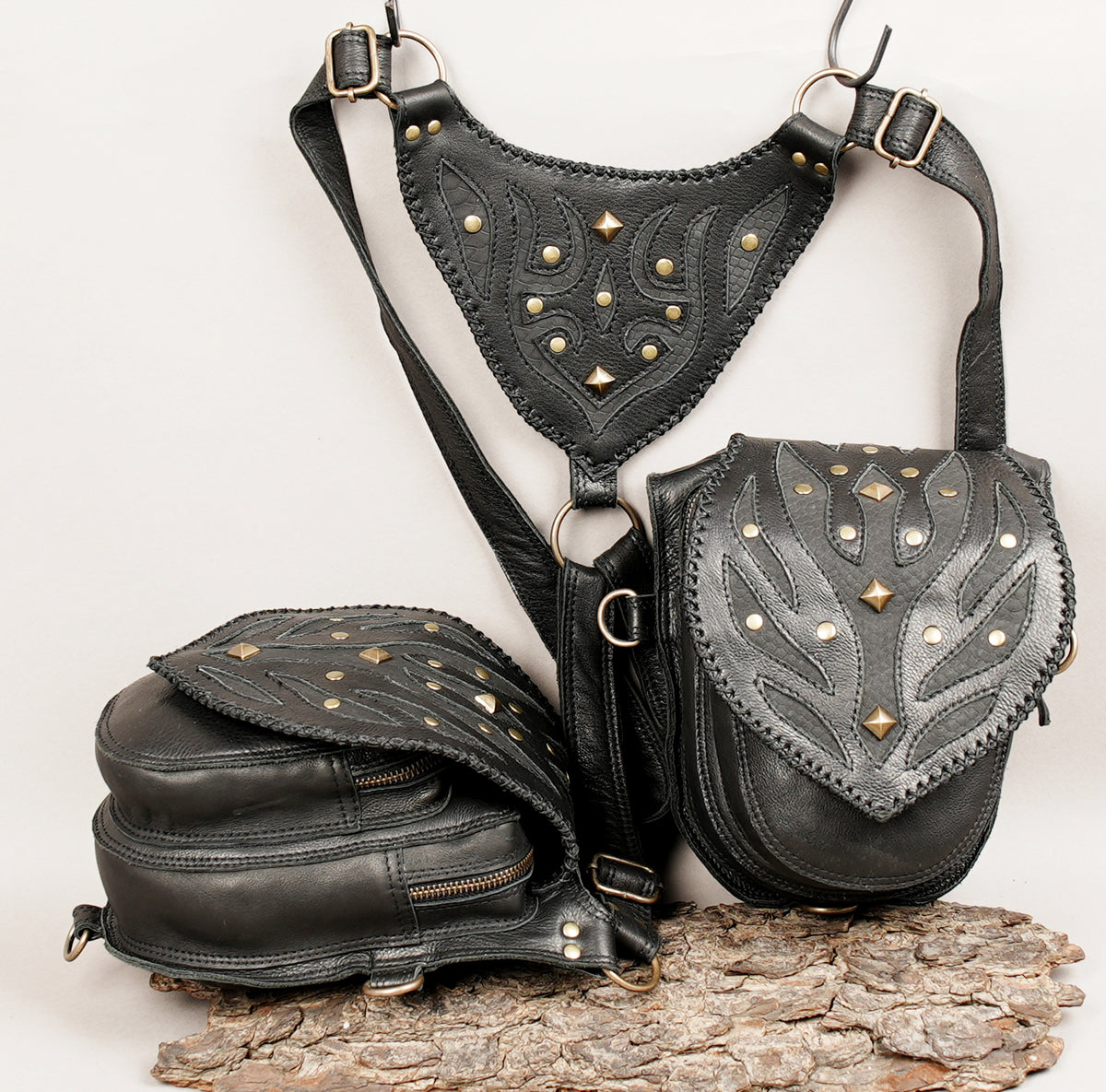 Three-piece black leather crossbody bag set with gold-tone studs and hardware.