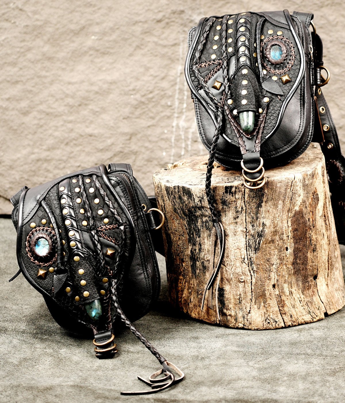 Alternative fashion black leather double pouch harness with intricate stitching and metal studs
 