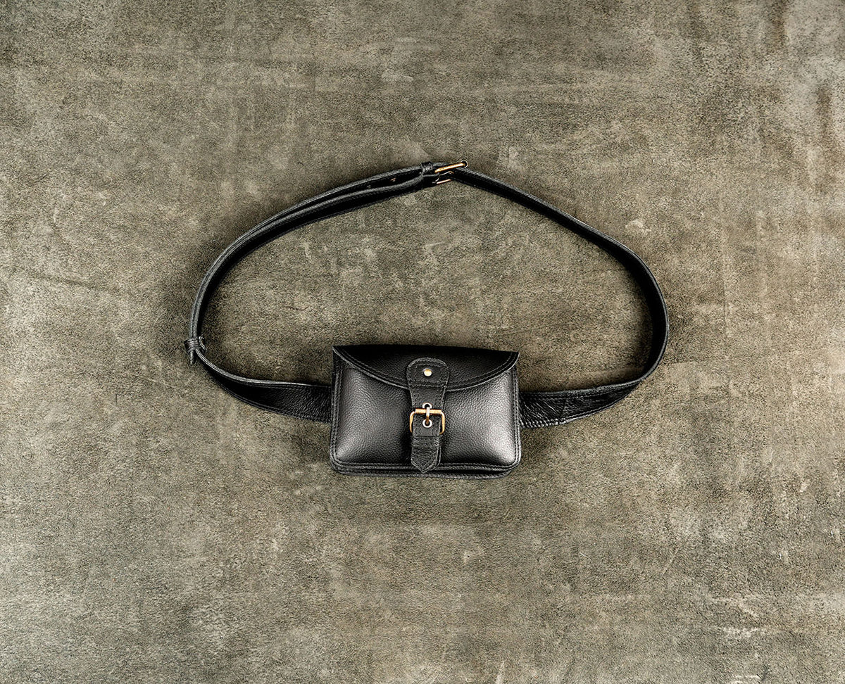 Durable black leather fanny pack with adjustable strap and brass fittings