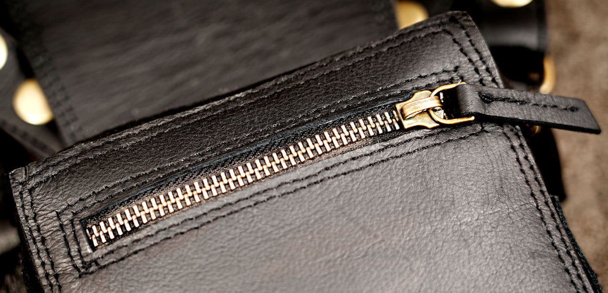Artisan leather shoulder harness with two pouches and studded detailing