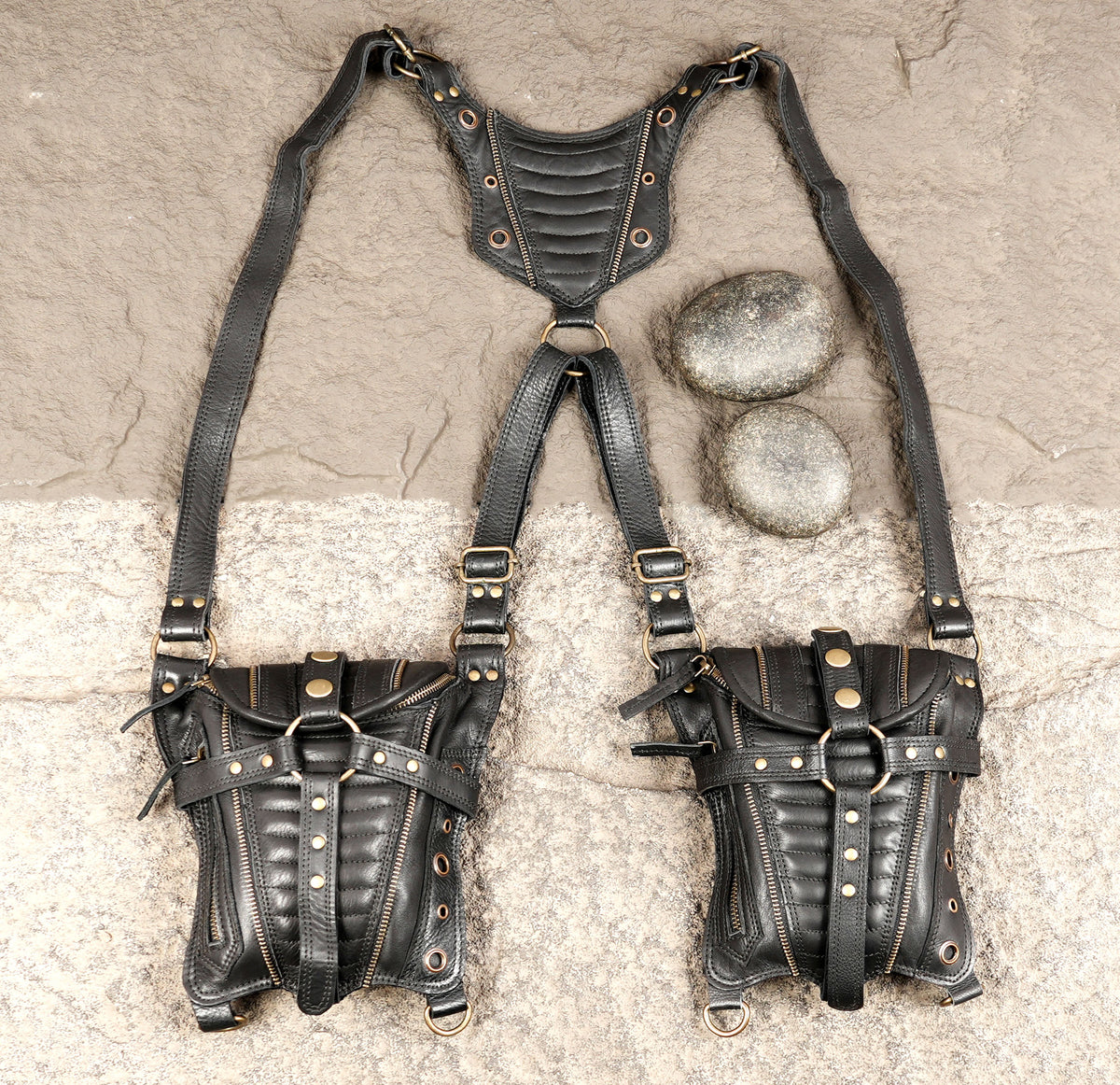 Black utility hip bag with two zippered pouches brass-tone studs and adjustable straps