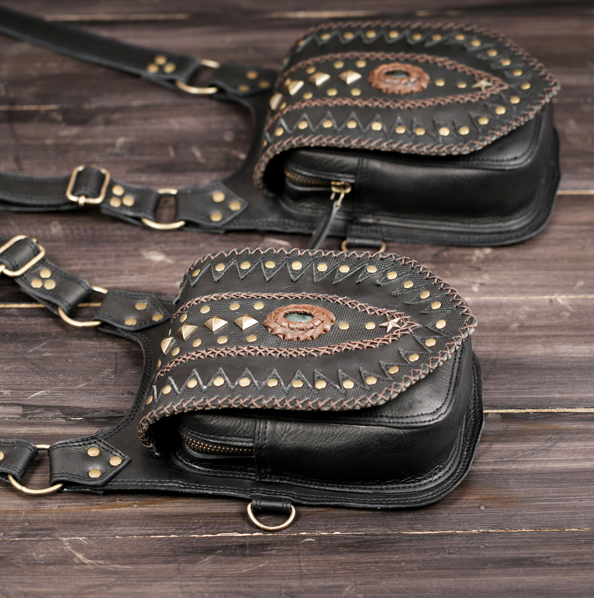 Gothic black leather double waist bag with ornate studded flap designs
 