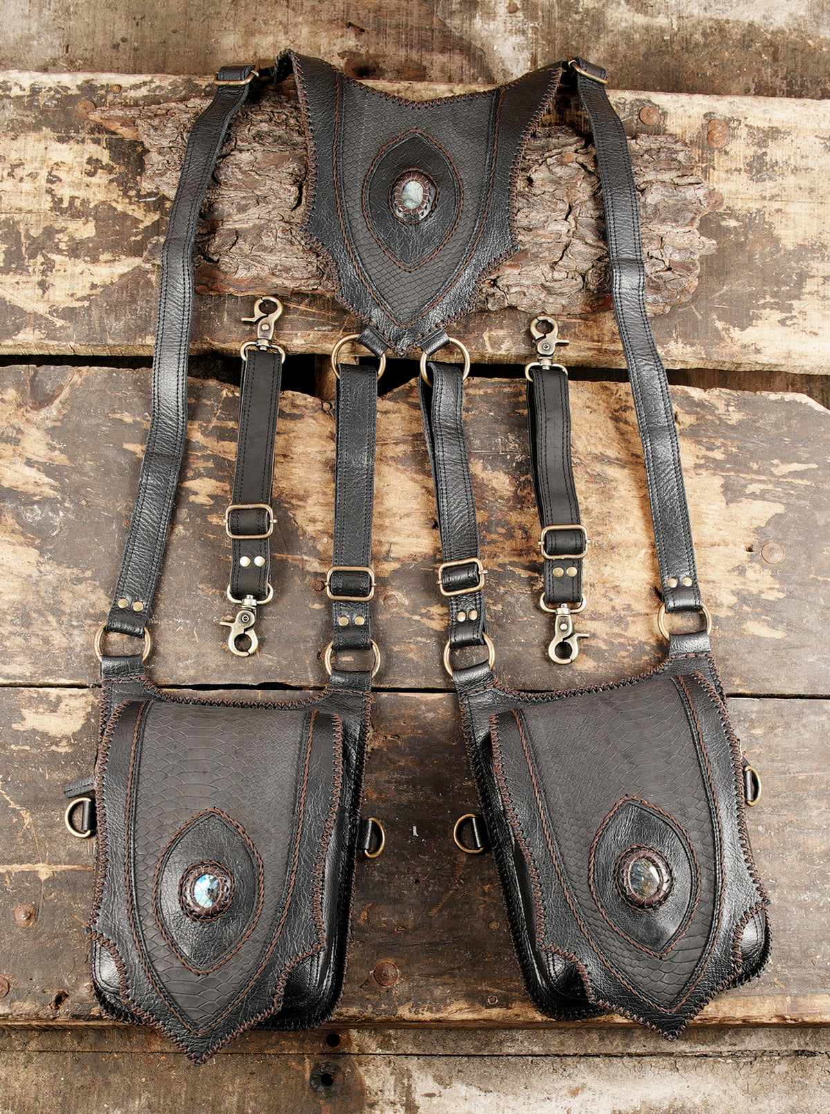 Handcrafted gothic utility gear with double shoulder holsters and brass accents   