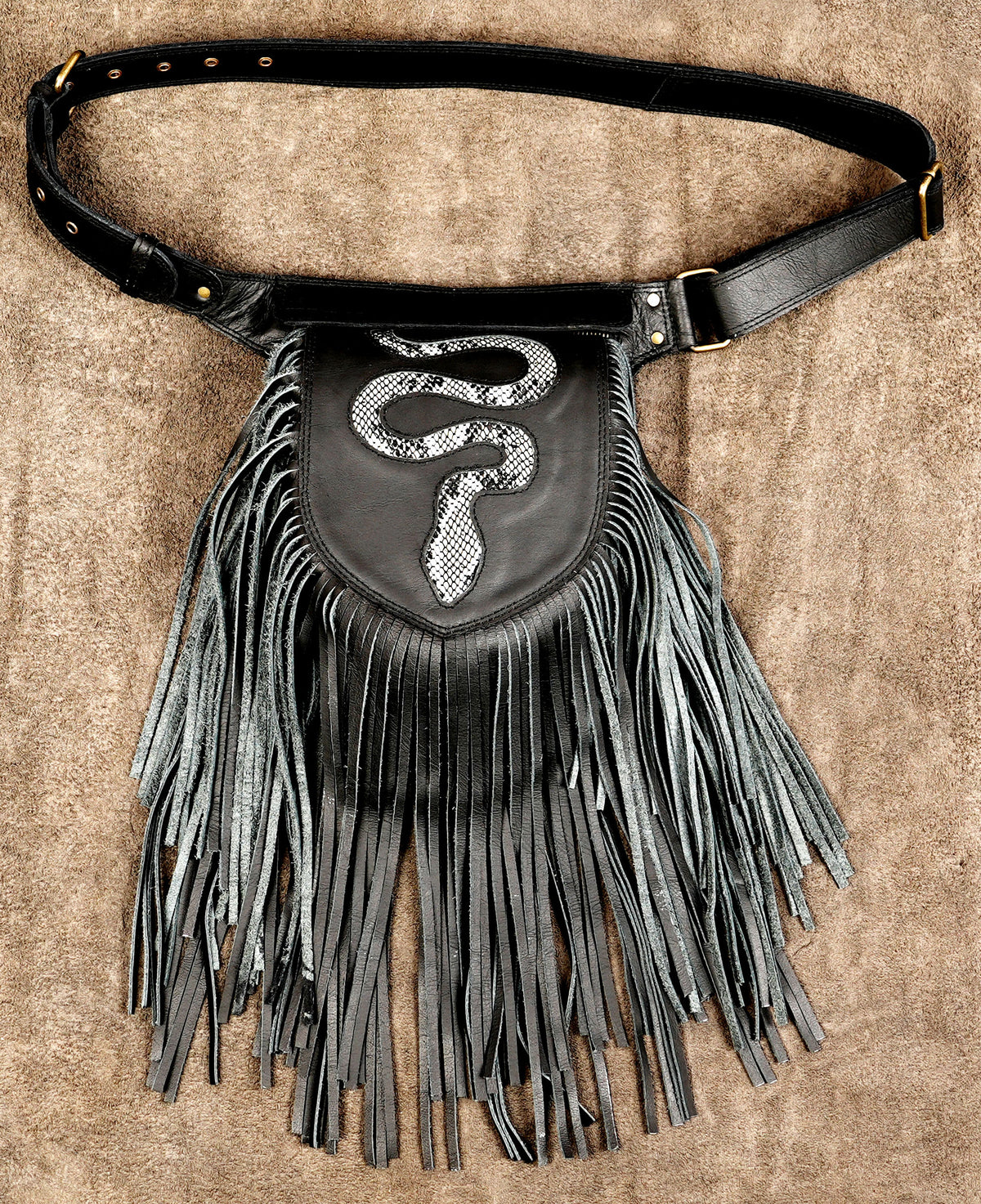 Black leather fringed pouch bag with a silver snake design on the front, displayed flat on a brown textured background.