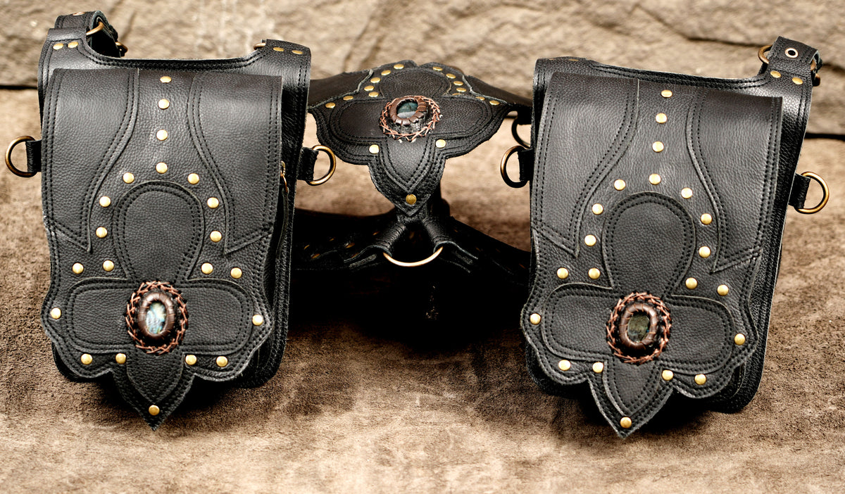 Handmade leather festival bag with gemstone accents and adjustable shoulder straps
