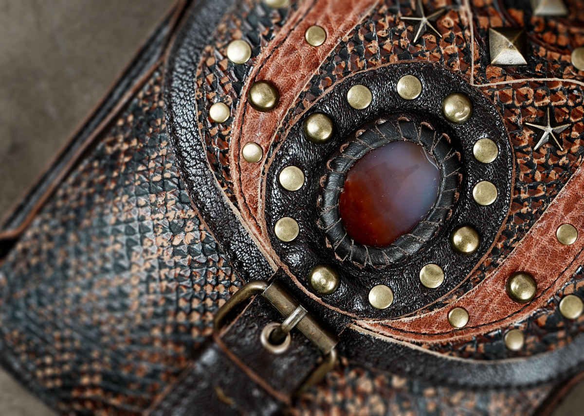 Leather festival harness bag with gemstone embellishments and decorative metal studs.