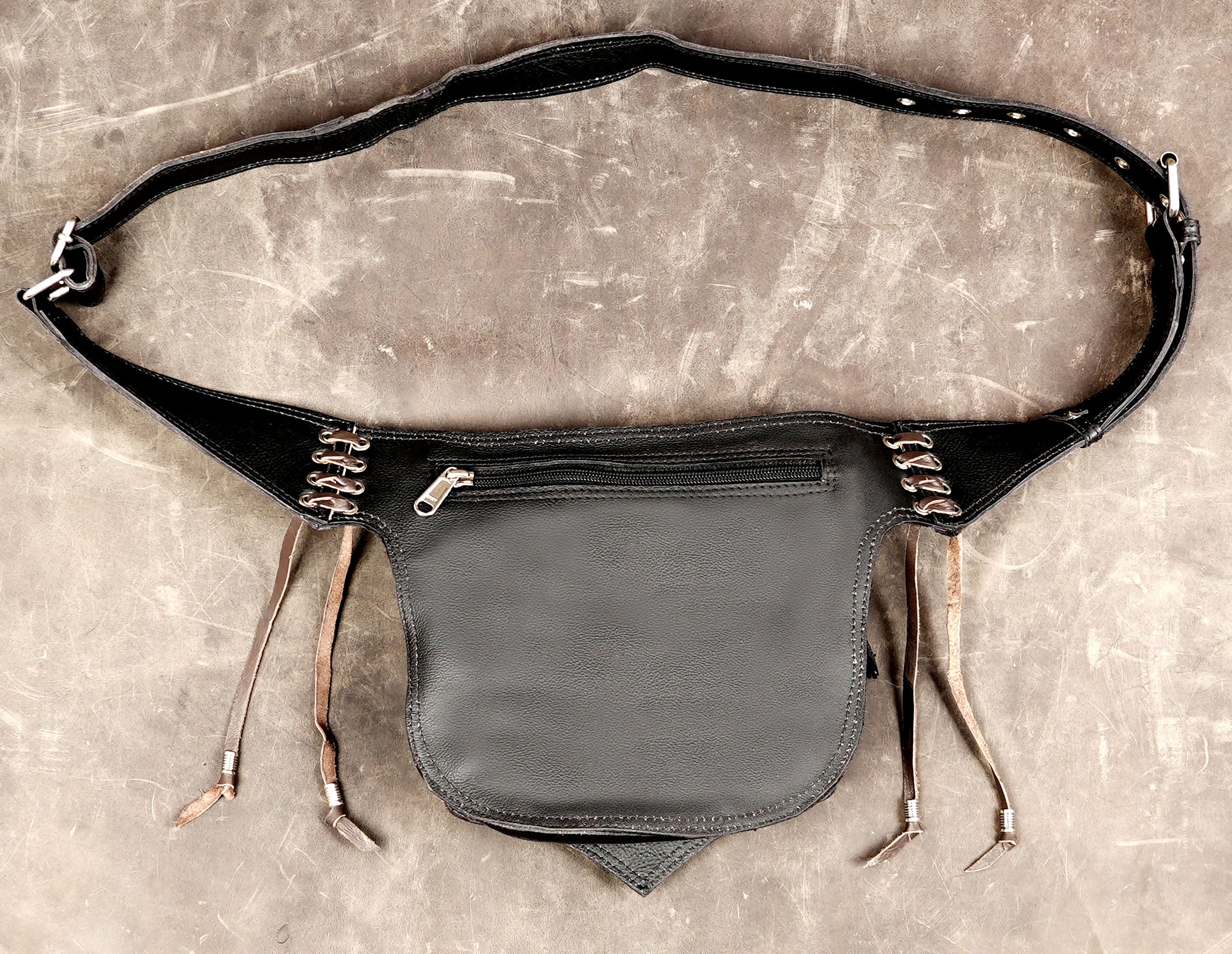 Boho leather accessory with pointed base and fringe