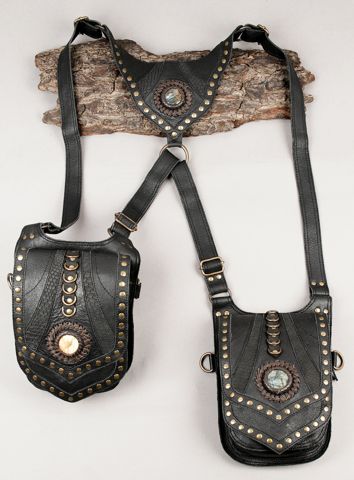 Handmade gothic harness bag with textured panels and brass-tone rivets
