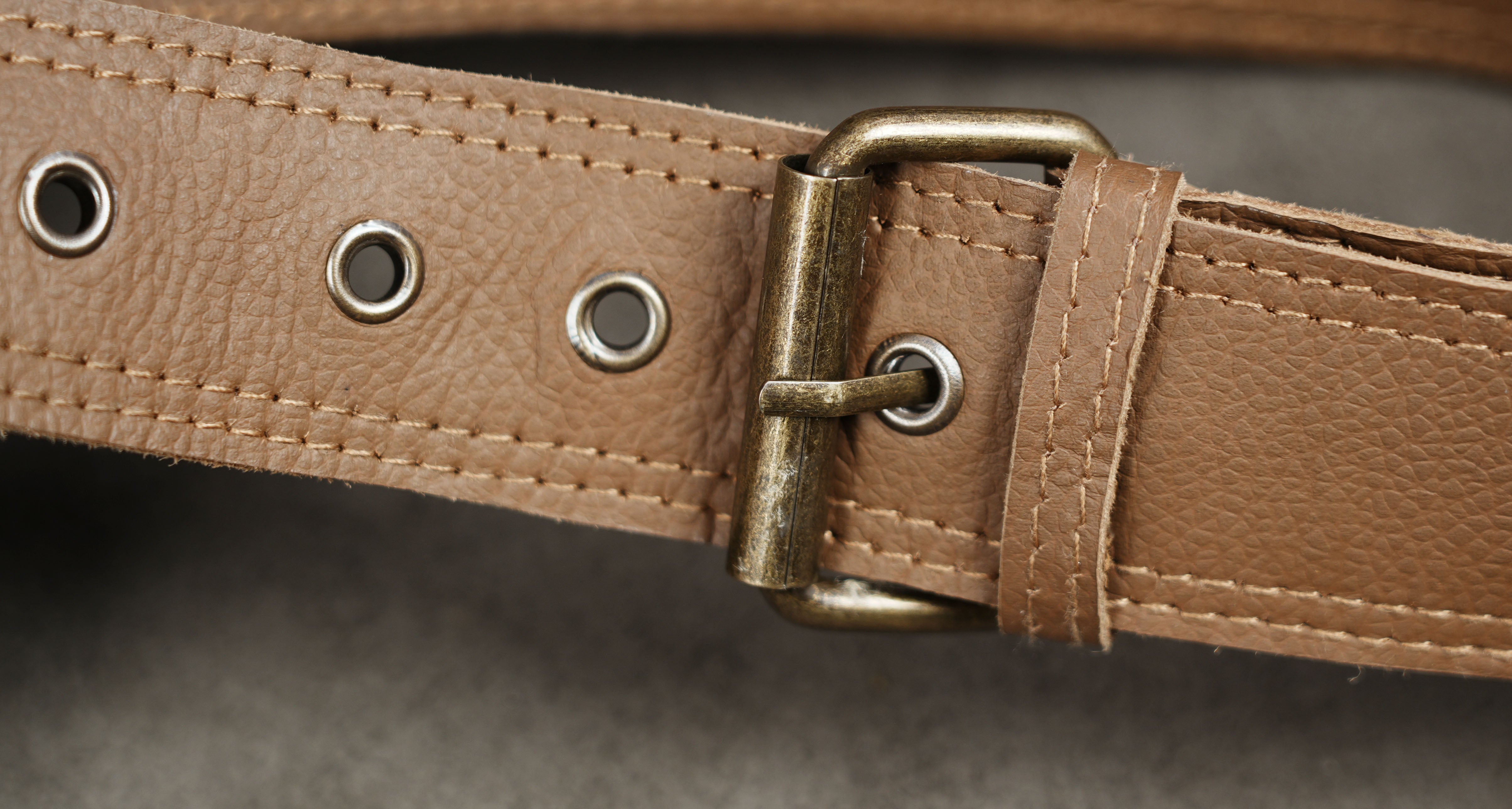 Brown leather fanny pack with antique brass hardware