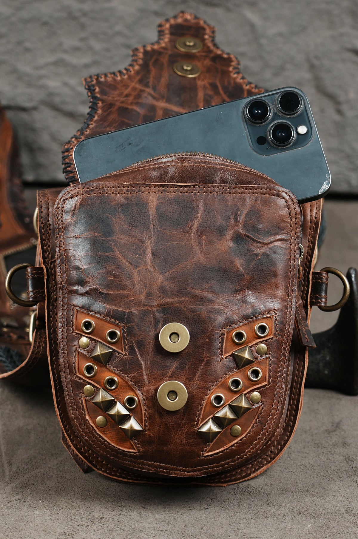 Decorative leather shoulder rig with matching pouches and intricate metal embellishments
