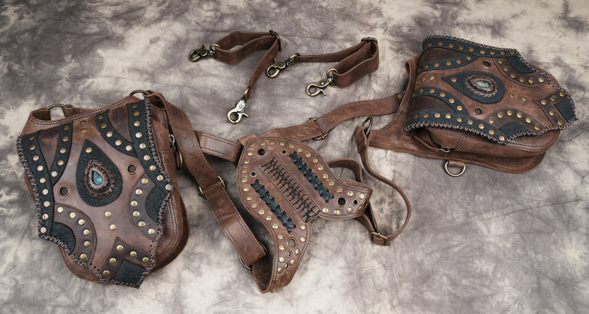 Dark brown leather hip pouch set with geometric black panels and intricate edge stitching.