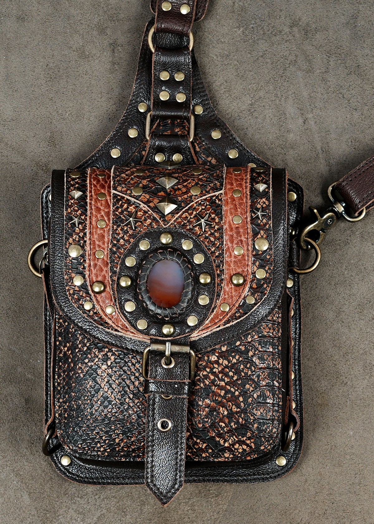Steampunk shoulder holster bag set with brown leather straps and antique-style metal fittings.