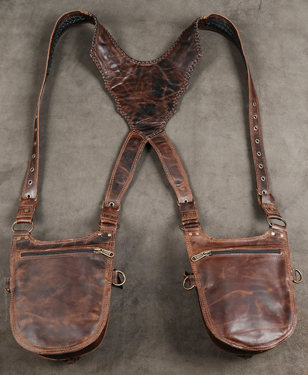 Festival shoulder bag harness with studded brown leather pouches and reinforced edges