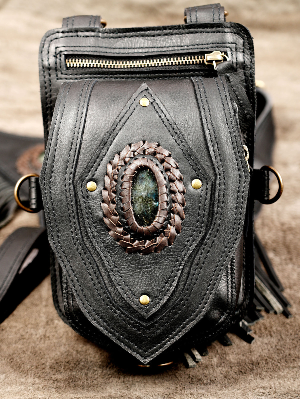 Hands-free dual shoulder leather holster bag with adjustable chest straps and secure zip compartments.