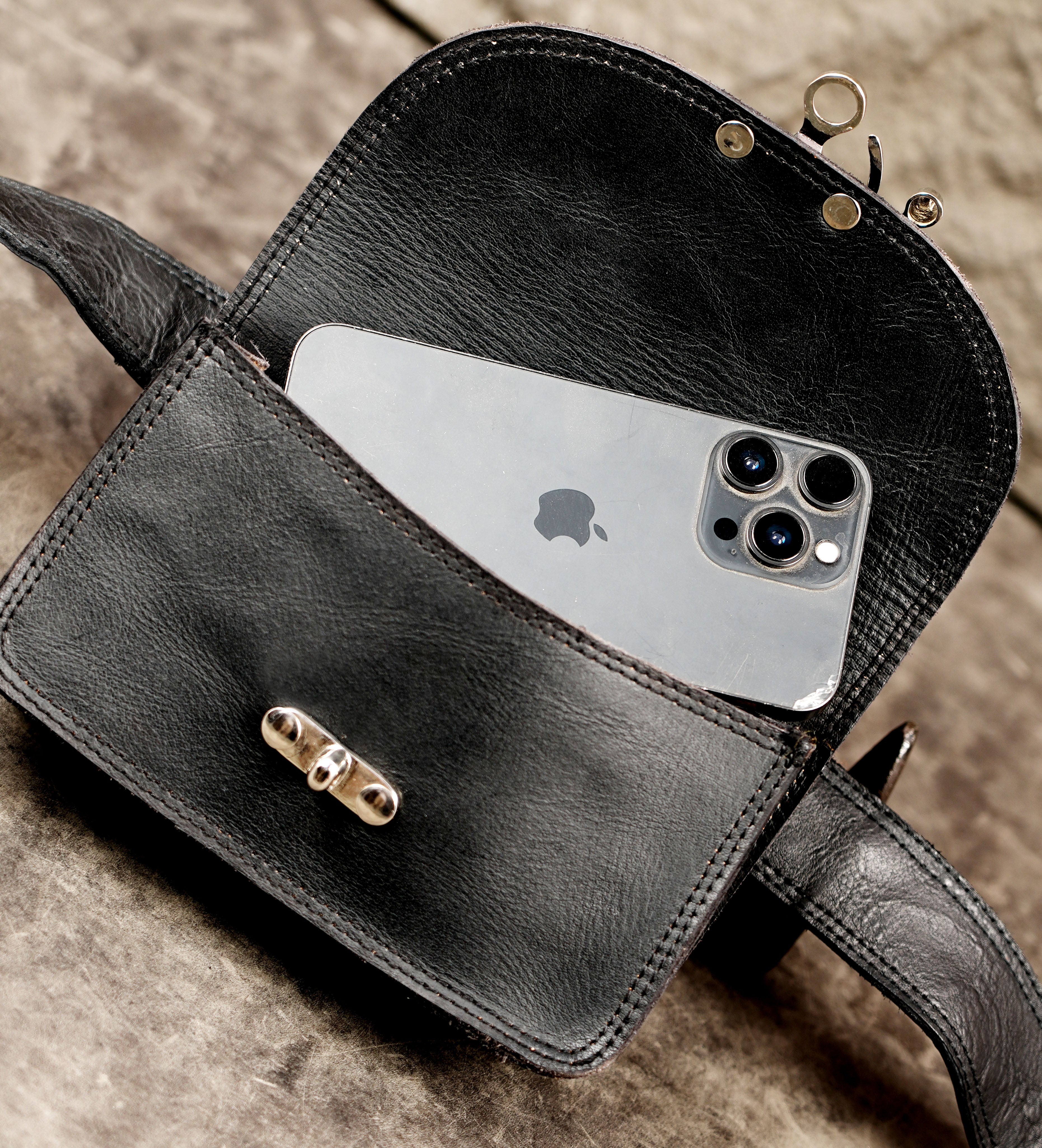 Clean leather hip bag with silver clasp, full flat lay view
