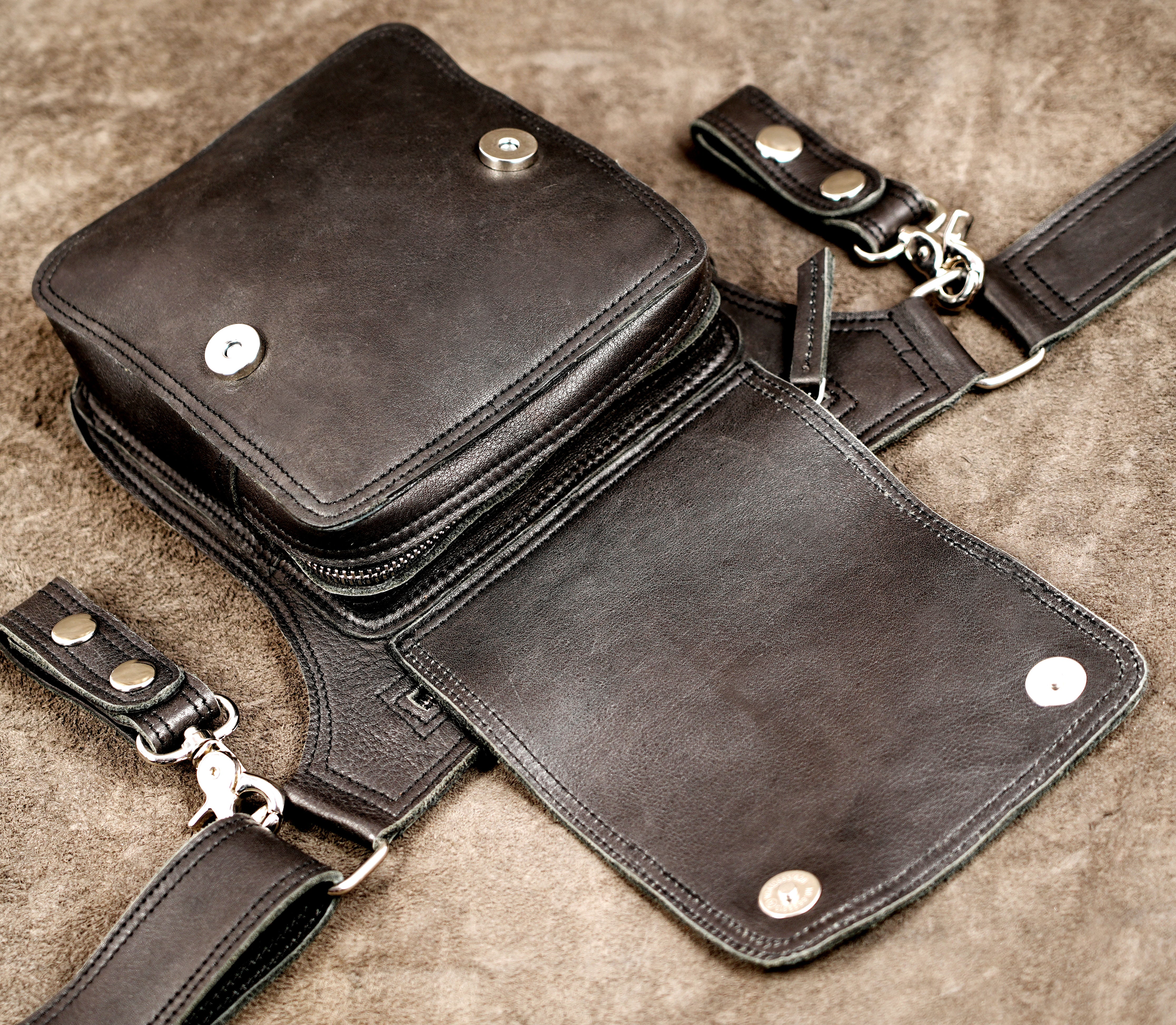 Clean leather hip bag with snap pockets, full flat lay view