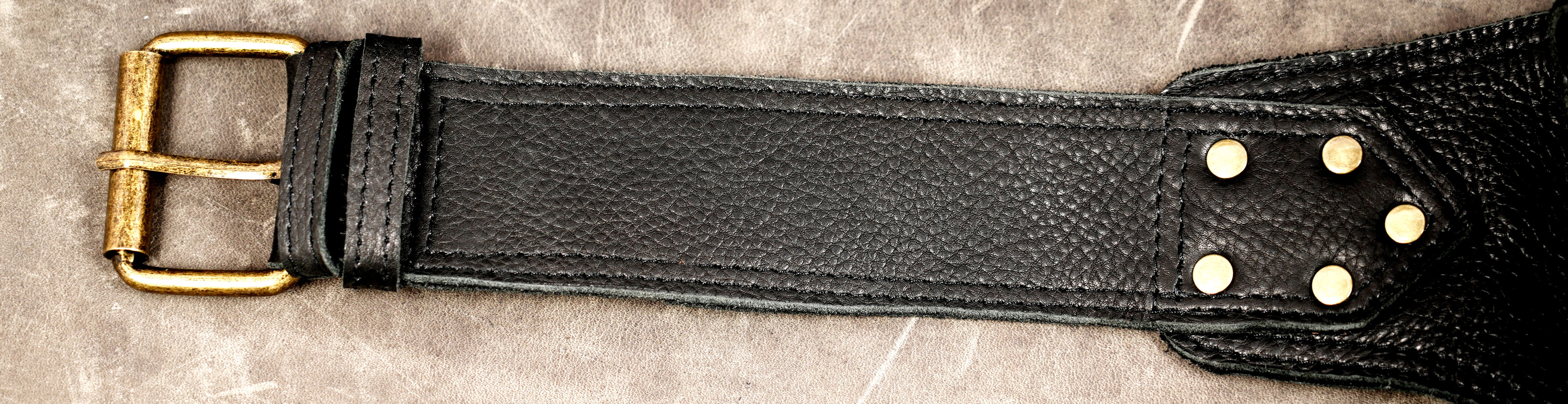 Compact black leather waist pouch with decorative metal studs