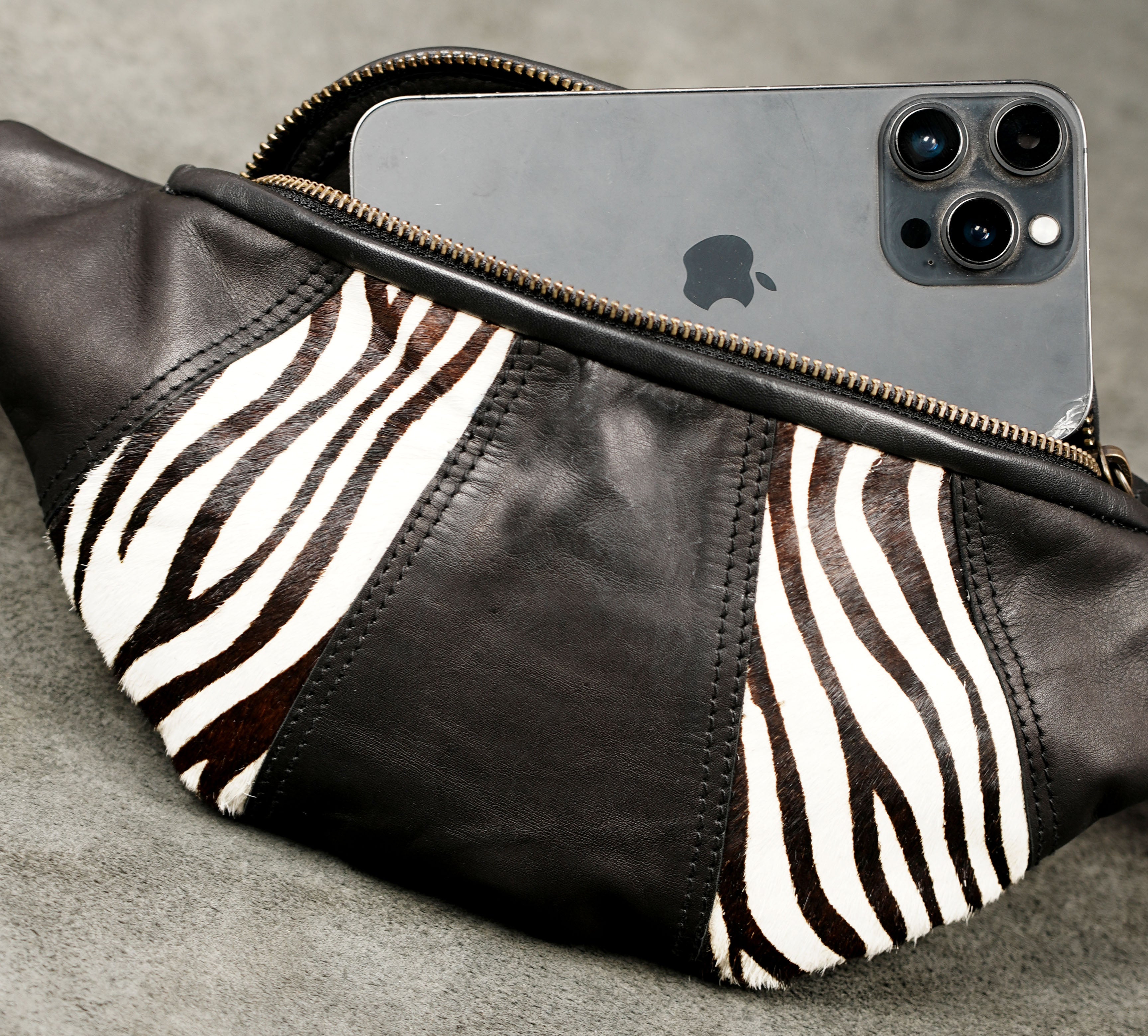 Compact zebra-print crossbody bag with zipper closure