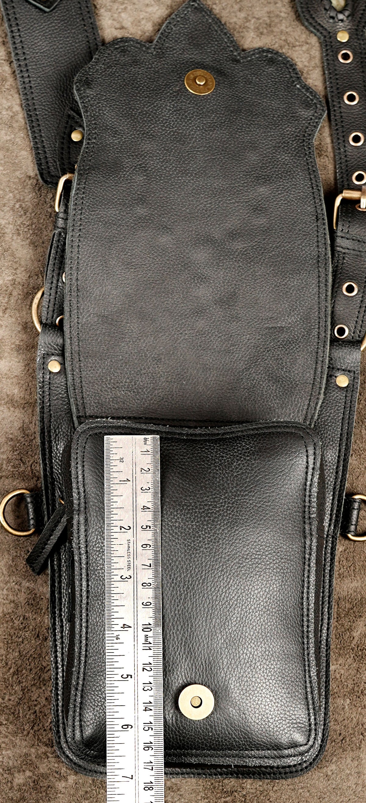 Handmade black leather rave bag with gemstone details and studded flaps