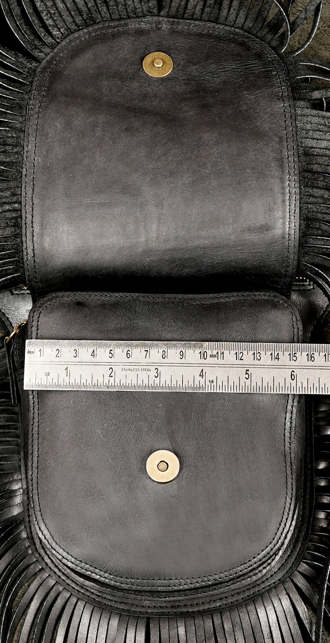 Cowgirl style leather bag with fringe and gemstone accent