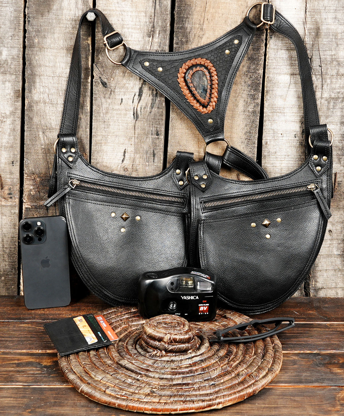 Unisex black leather utility harness bag with dual zippered pockets for Burning Man and music festivals.