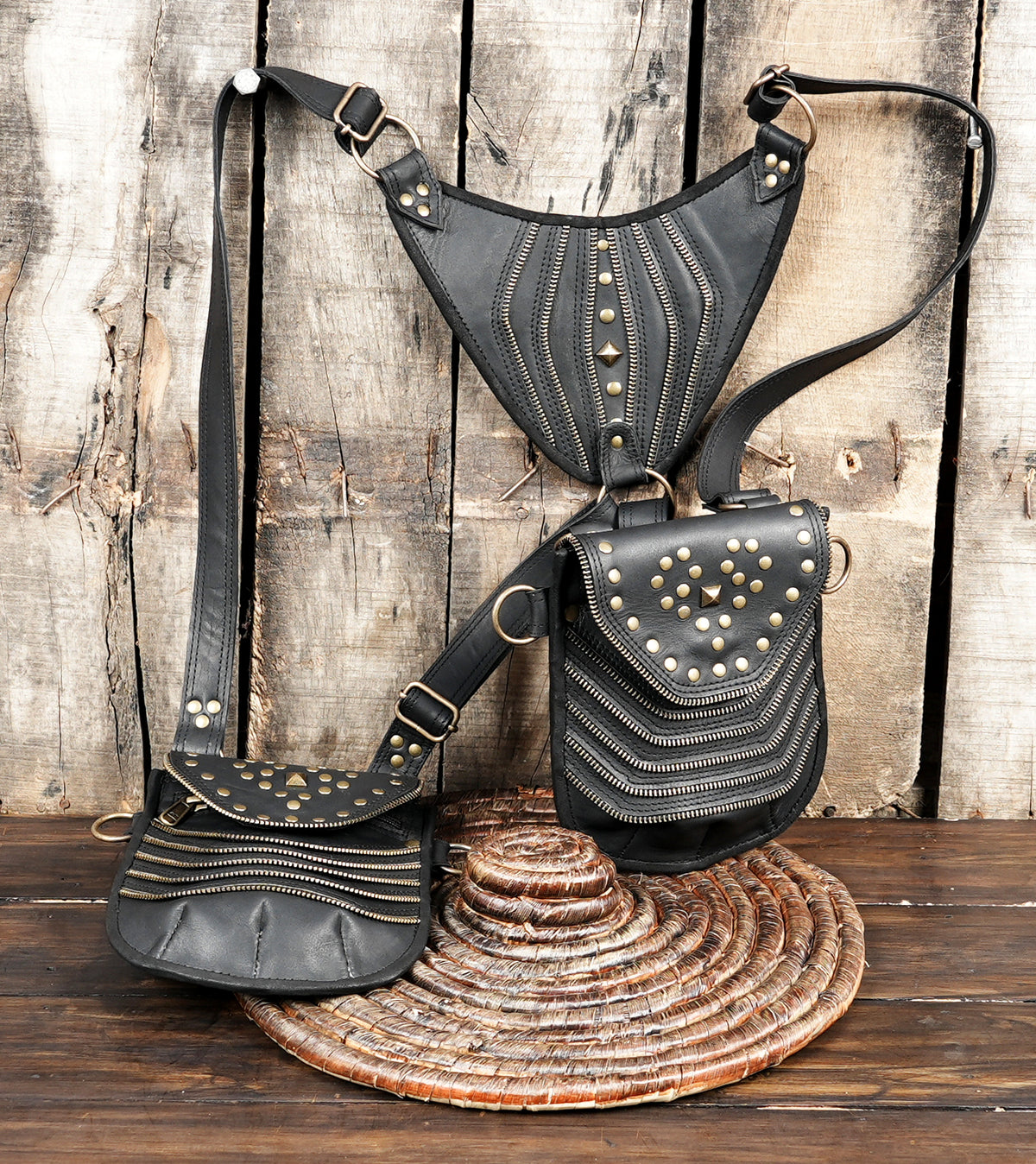 Black leather festival harness bag with two storage pouches and studded flap covers