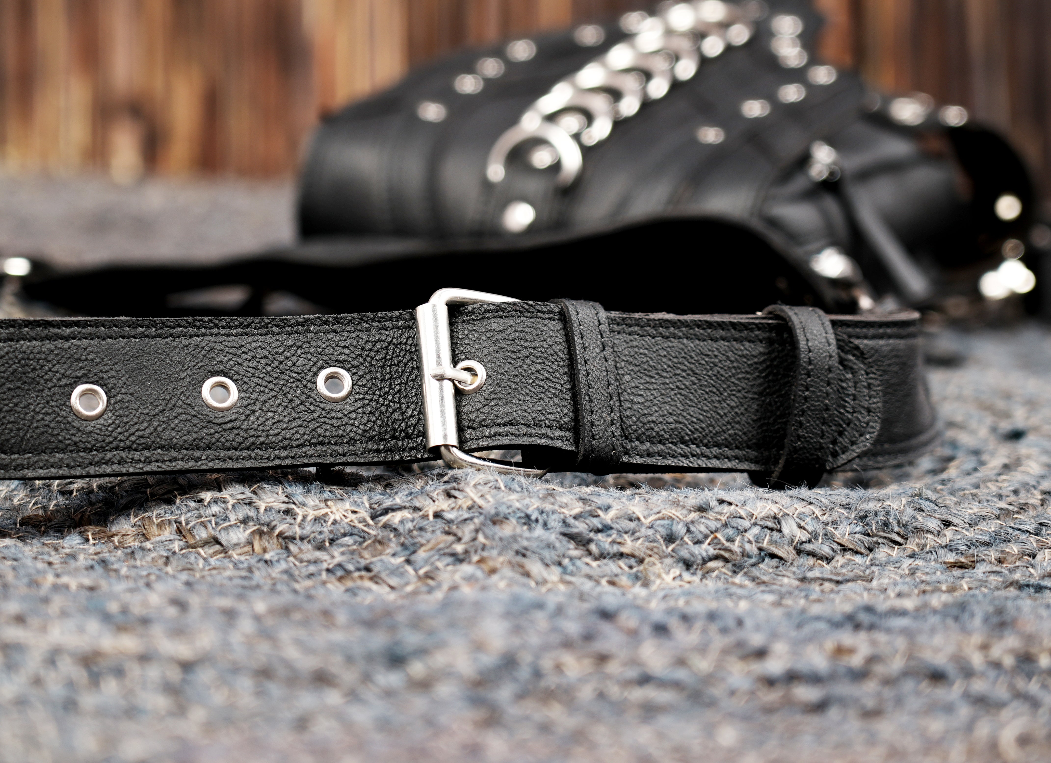 Black leather pocket belt with adjustable straps and ring details