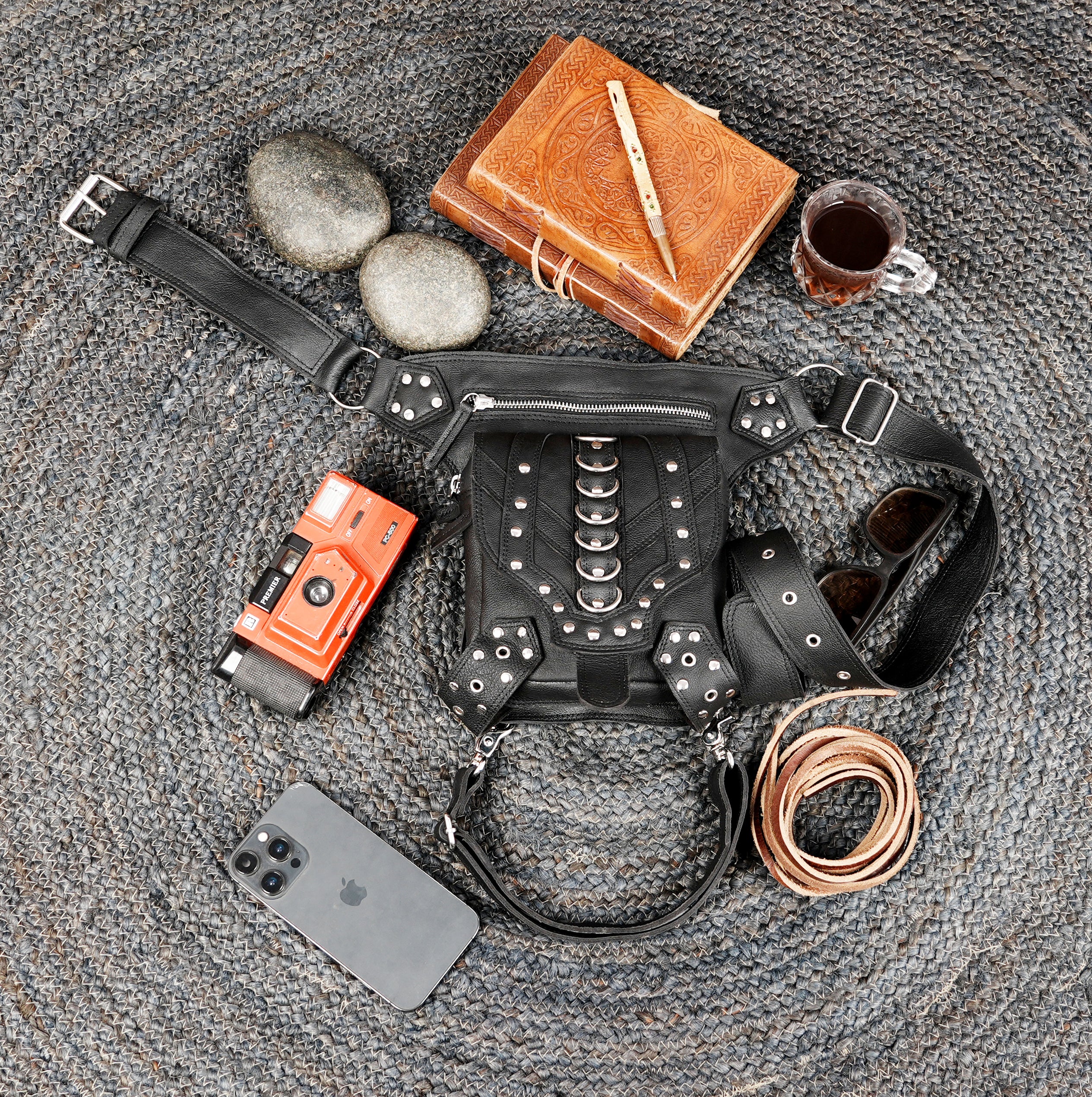 Multi-strap black leather thigh holster with decorative hardware