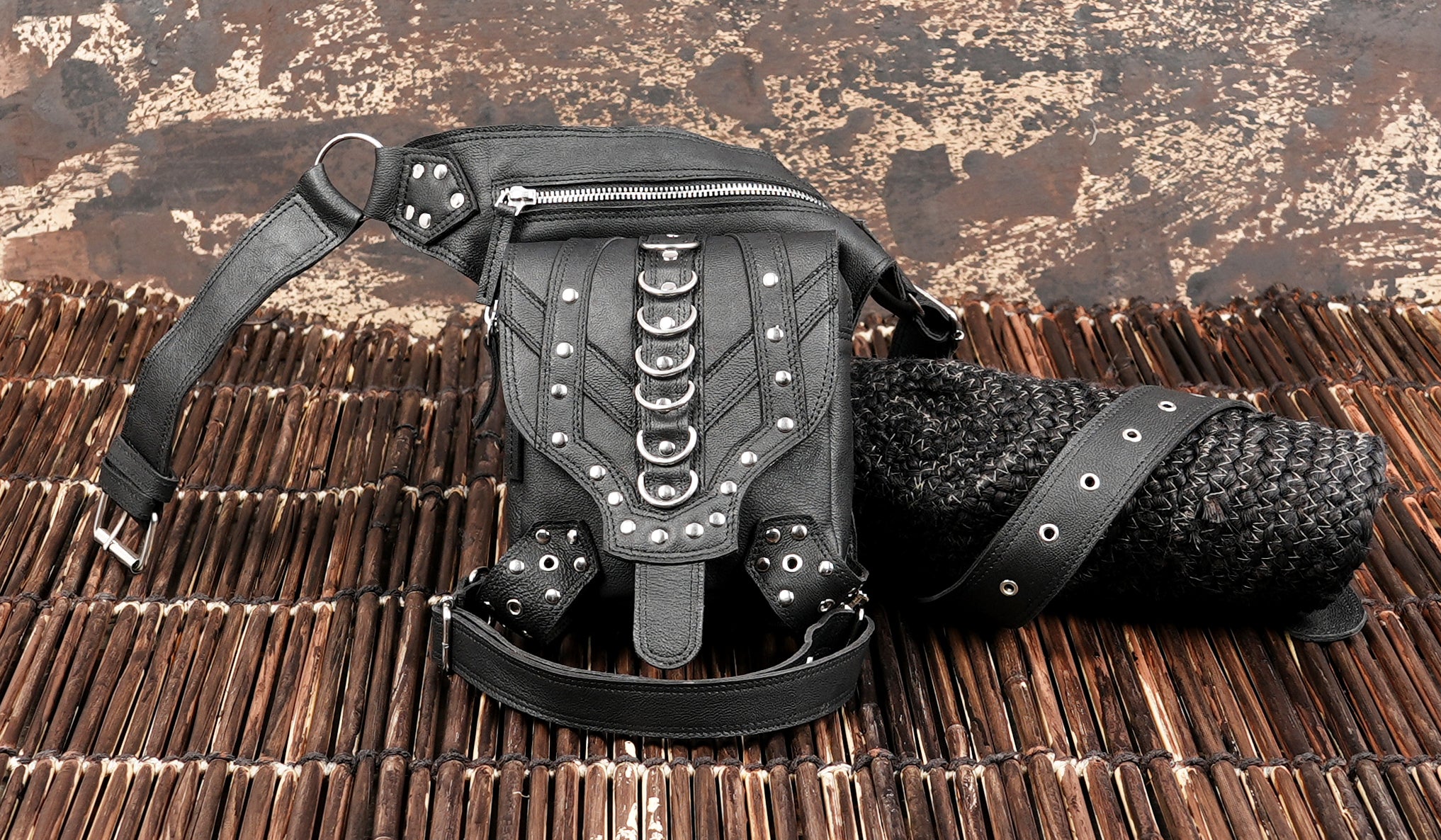 Rugged black leather belt with thigh and metal detailing