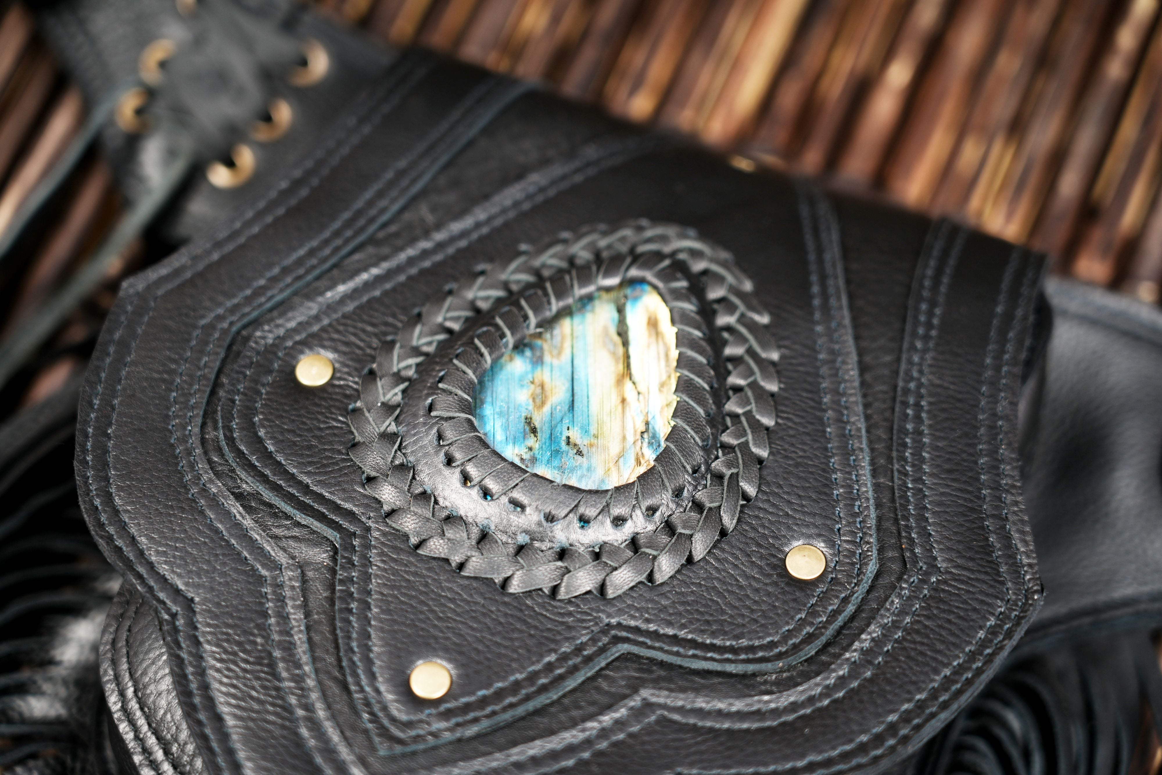 Artisan leather waist bag with fringe and blue stone accent