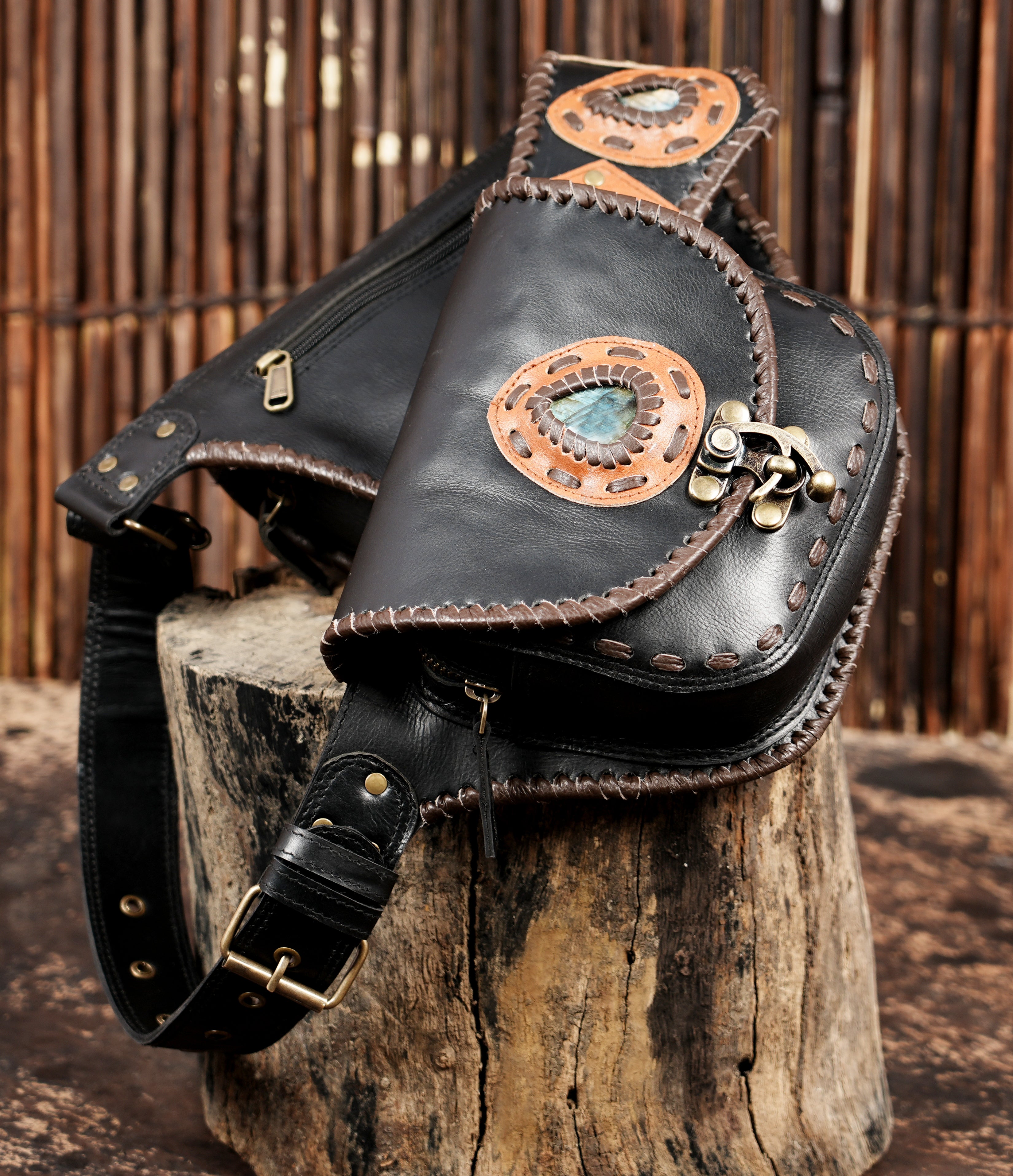 Black leather belt bag with turn-lock clasps and tan leather trim